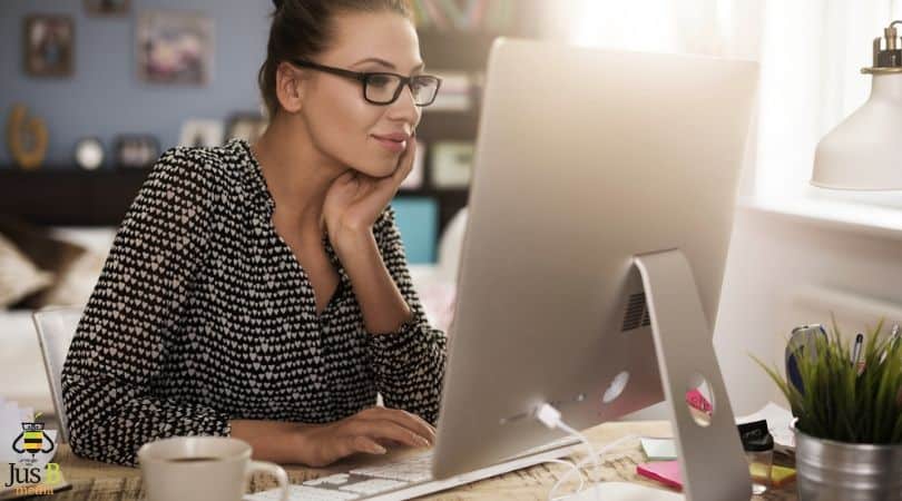 lady sitting at desktop computer looking at the screen