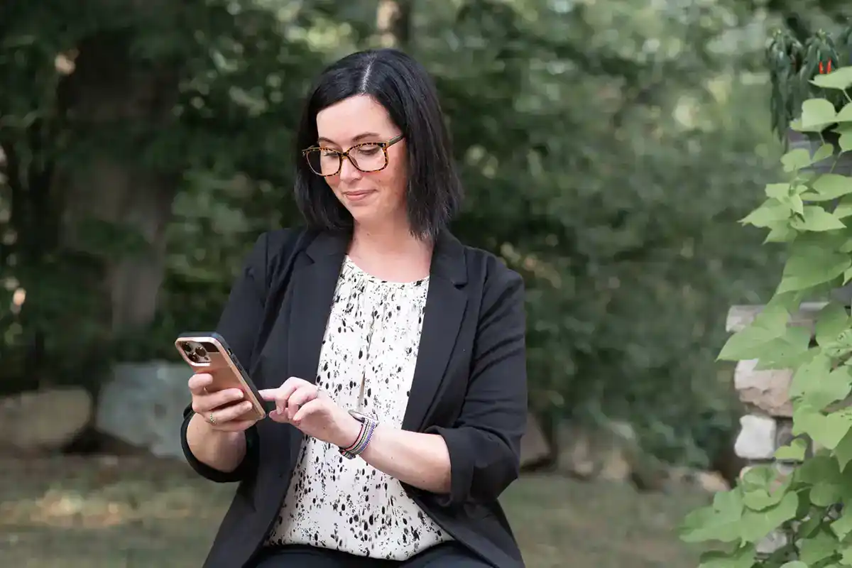 Woman looking at a phone reviewing an Website Audit